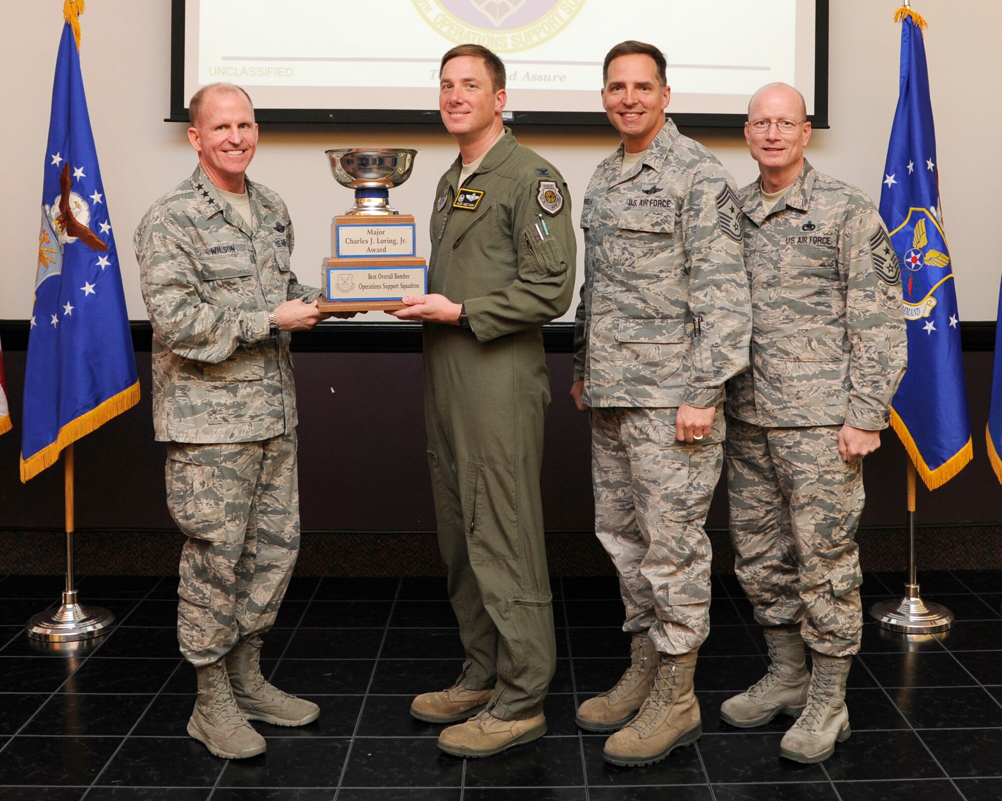 Lt. Gen. Stephen Wilson, Air Force Global Strike Command commander presents the Major Charles J. Loring, Jr. Award for Best Overall Bomber Support Squadron to Col. Alexis Mezynski, 5th Bomb Wing commander during a ceremony at Barksdale Air Force Base, April 9. The award is presented annually to the wing recognized as the best in their field. (U.S. Air Force photo/Senior Airman Joseph A. Pagán Jr.)