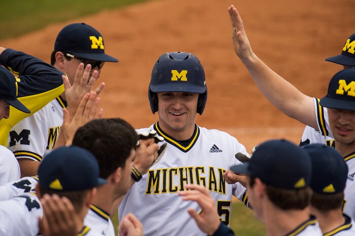 University of Michigan catcher Harrison Wenson, gets congratulated after hitting a home run against Kent State University at the College of Charleston Tournament, March 16, 2014, in Charleston, S.C. The University of Michigan would go on to beat Kent State University 3-2. (U.S. Air Force photo/Senior Airman James Richardson)