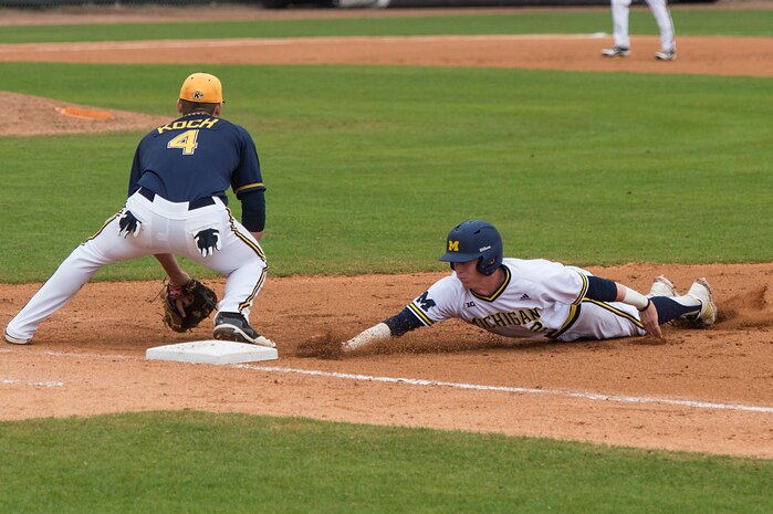 University of Michigan infielder Jacob Cronenworth, slides into first base during a game against Kent State University at the College of Charleston Tournament March 16, 2014, in Charleston, S.C. The University of Michigan would go on to beat Kent State University 3-2. (U.S. Air Force photo/Senior Airman James Richardson)
