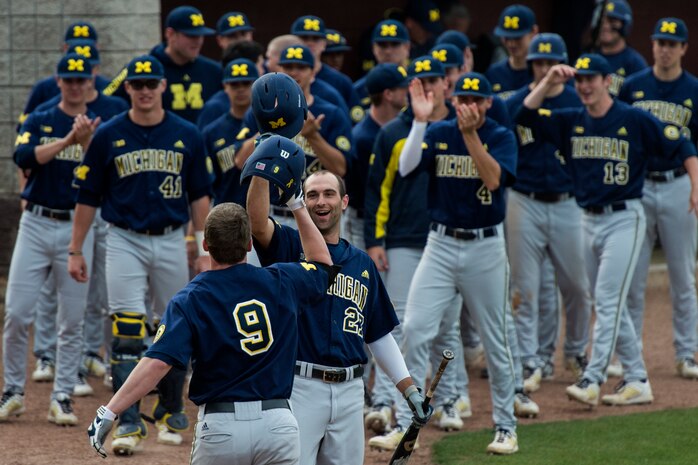 University of Michigan outfielder Travis Maezes, is congratulated after hitting a home run against the College of Charleston at the College of Charleston Tournament March 15, 2014, in Charleston, S.C. The University of Michigan would go on to lose both games of a double header. (U.S. Air Force photo/Senior Airman James Richardson)