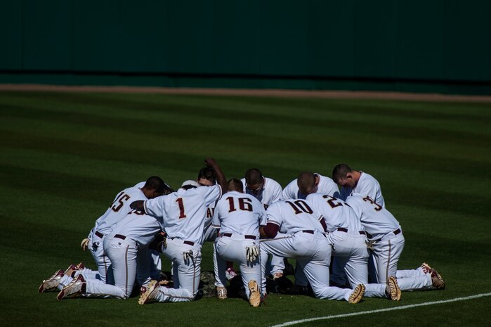 College of Charleston players gather to pray before a game against Kent State University at the College of Charleston Tournament March 14, 2014, in Charleston, S.C. Kent State would go on to win the game 8-6.  (U.S. Air Force photo/Senior Airman James Richardson)