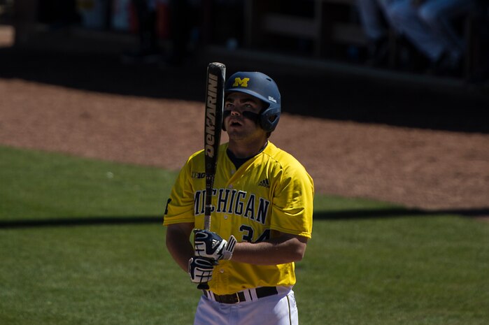 University of Michigan right fielder Kyle Jusick, inspects his bat before batting against Appalachian State University at the College of Charleston Tournament March 14, 2014, in Charleston, S.C.  The University of Michigan would go on to win the game 4-3. (U.S. Air Force photo/Senior Airman James Richardson)