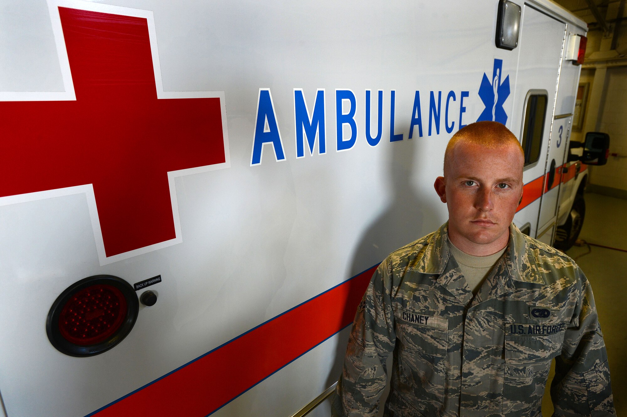 U.S. Air Force Airman 1st Class Jacob Chaney, 20th Logistic Readiness Squadron vehicle and equipment maintenance apprentice, stands in front of an ambulance at Shaw Air Force Base, S.C., April 9, 2014. Early morning on April 6, Chaney administered self-aid and buddy care to a young woman with severe cuts on her arm before rushing her to the hospital. (U.S. Air Force photo by Airman 1st Class Jensen Stidham/Released)