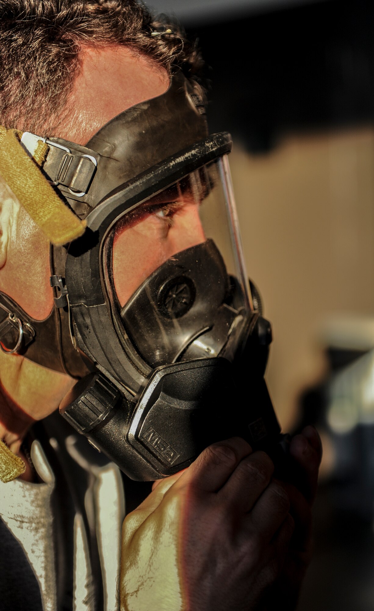 U.S. Air Force Col. Chad Franks, 23d Wing commander, tests the fit of his MSA firehawk mask at Moody Air Force Base, Ga., April 9, 2014. Franks participated in a live-fire exercise with the 23d Civil Engineer Squadron fire emergency services flight, which tested them on readiness and response times. (U.S. Air Force photo by Airman 1st Class Alexis Millican/Released)