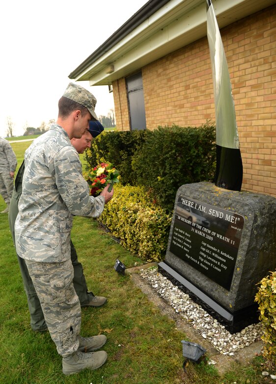 U.S. Air Force Lt. Col. Clay Freeman, right, 7th Special Operations Squadron commander, and Capt. Brandon Pryor, 25th Intelligence Squadron Detachment 2 commander, lay a wreath on the WRATH-11 memorial monument March 28, 2014, during a remembrance ceremony on RAF Mildenhall, England. The memorial includes a propeller from WRATH-11, an MC-130H Combat Talon II assigned to the 7th SOS, which crashed in Albania in 2005. The ceremony was held in honor of the 9th anniversary of the nine Airmen who died when WRATH-11. (U.S. Air Force photo by Airman 1st Class Jonathan Light/Released)