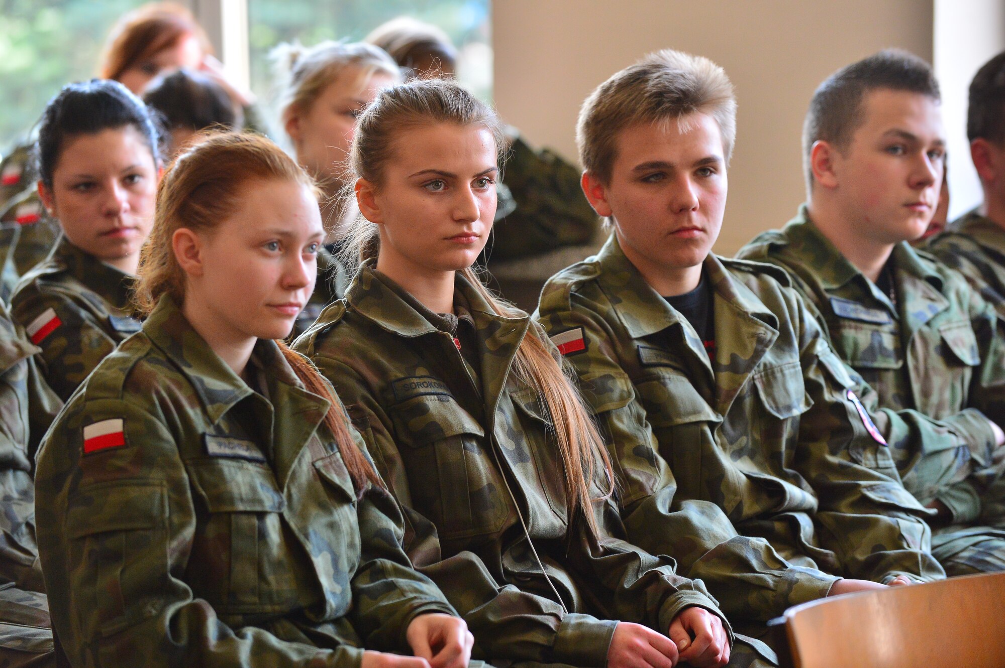 A Gen. Dr. Romana Abrahama Secondary School student receives instruction from a U.S. Air Force C-130J Super Hercules pilot on the use and importance of a flight helmet and oxygen mask, in Wrzesnia, Poland, April 4, 2014 during the U.S. Aviation Detachment 14-2 rotation. The students are equivalent to U.S. Air Force Junior Reserve Officer Training Corps.  (U.S. Air Force photo/Tech. Sgt. Daylena S. Ricks)