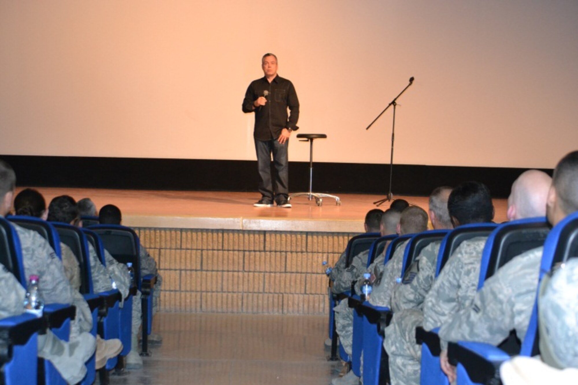 Comedian Bernie McGrenahan presents his “Happy Hour” show to service members at Al Udeid Air Base, April 9 2014. This month, the Department of Defense observes the tenth annual of Sexual Assault Awareness Month with the message of “Live Our Values:  Step Up to Stop Sexual Assault.”  In support of this initiative, 379th Air Expeditionary Wing leadership invited McGrenahan, a comedian who delivers a comedy show followed by a powerful training and prevention-based session. As one of the military’s top-requested prevention and risk-reduction programs, McGrenahan inspires troops to stay focused and resilient by sharing his personal life testimony.  (U.S. Air Force Photo by Maj. Nicole David)