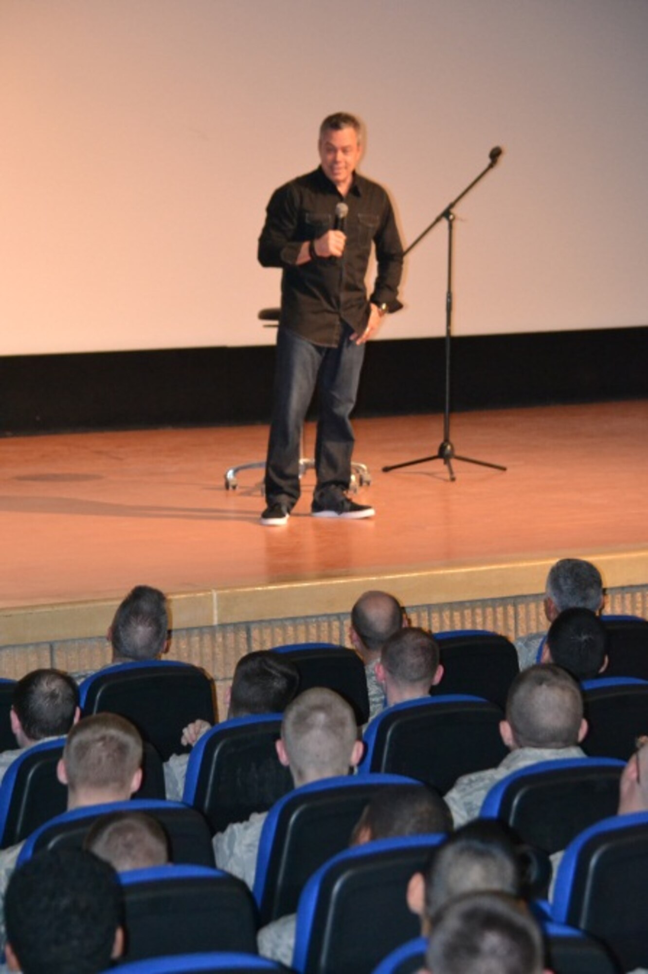 Comedian Bernie McGrenahan presents his “Happy Hour” show to service members at Al Udeid Air Base, April 9 2014. This month, the Department of Defense observes the tenth annual of Sexual Assault Awareness Month with the message of “Live Our Values:  Step Up to Stop Sexual Assault.”  In support of this initiative, 379th Air Expeditionary Wing leadership invited McGrenahan, a comedian who delivers a comedy show followed by a powerful training and prevention-based session. As one of the military’s top-requested prevention and risk-reduction programs, McGrenahan inspires troops to stay focused and resilient by sharing his personal life testimony.  (U.S. Air Force Photo by Maj. Nicole David)