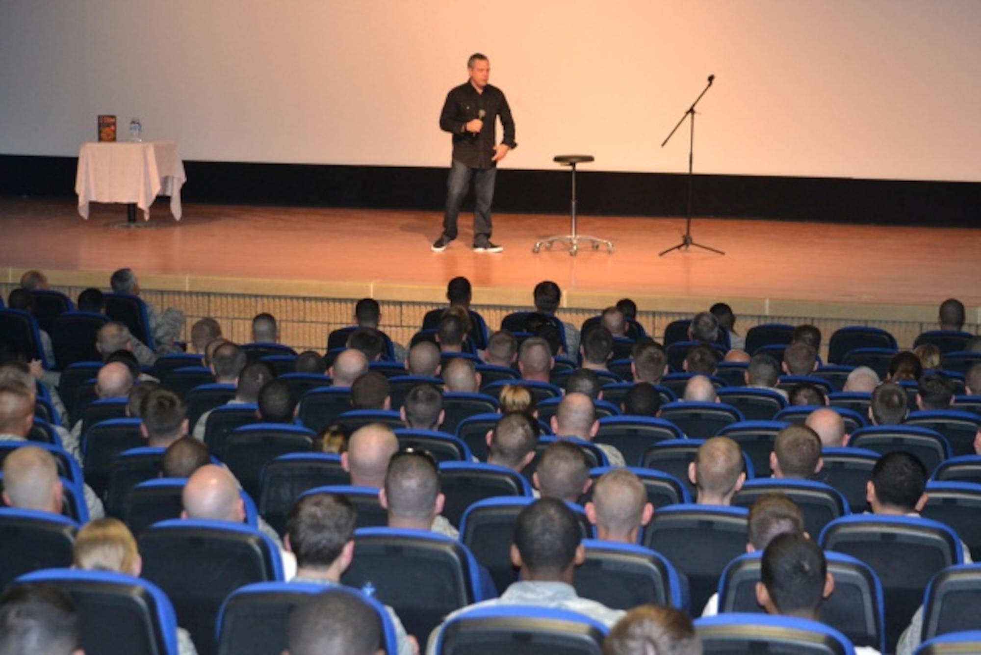 Comedian Bernie McGrenahan presents his “Happy Hour” show to service members at Al Udeid Air Base, April 9 2014. This month, the Department of Defense observes the tenth annual of Sexual Assault Awareness Month with the message of “Live Our Values:  Step Up to Stop Sexual Assault.”  In support of this initiative, 379th Air Expeditionary Wing leadership invited McGrenahan, a comedian who delivers a comedy show followed by a powerful training and prevention-based session. As one of the military’s top-requested prevention and risk-reduction programs, McGrenahan inspires troops to stay focused and resilient by sharing his personal life testimony.  (U.S. Air Force Photo by Maj. Nicole David)