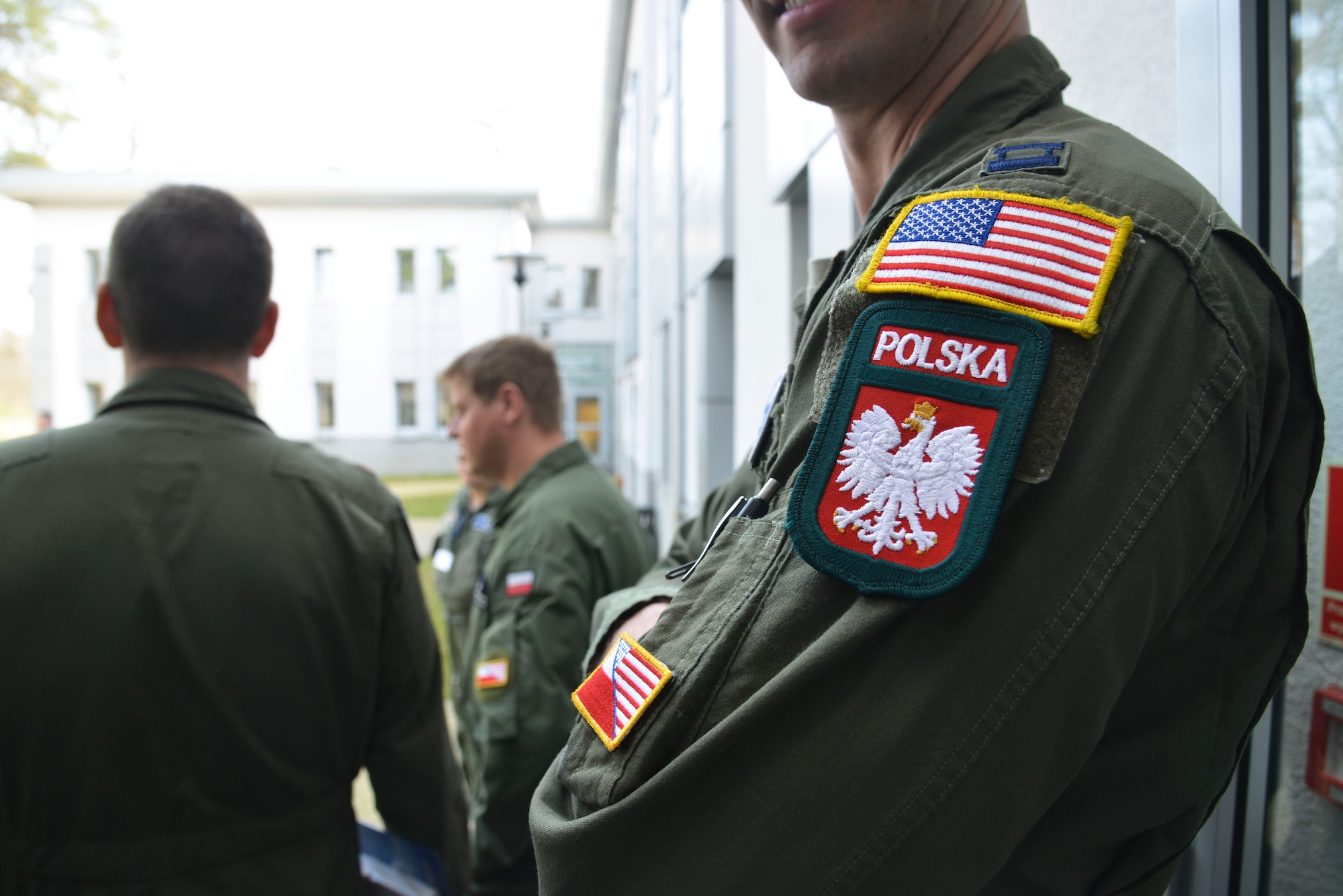 A U.S. pilot from the 86th Airlift Wing, Ramstein Air Base, displays his patches during training with Polish armed forces at Powidz Air Base, Poland, April 3, 2014. Three U.S. C-130J Super Hercules and more than 100 U.S. personnel will train to strengthen partnership capacity for real-world NATO operations until April 12 at the U.S. Aviation Detachment, which fosters bilateral defense ties with NATO allies. (U.S. Air Force photo by 2nd Lt. Katrina Cheesman/Released)