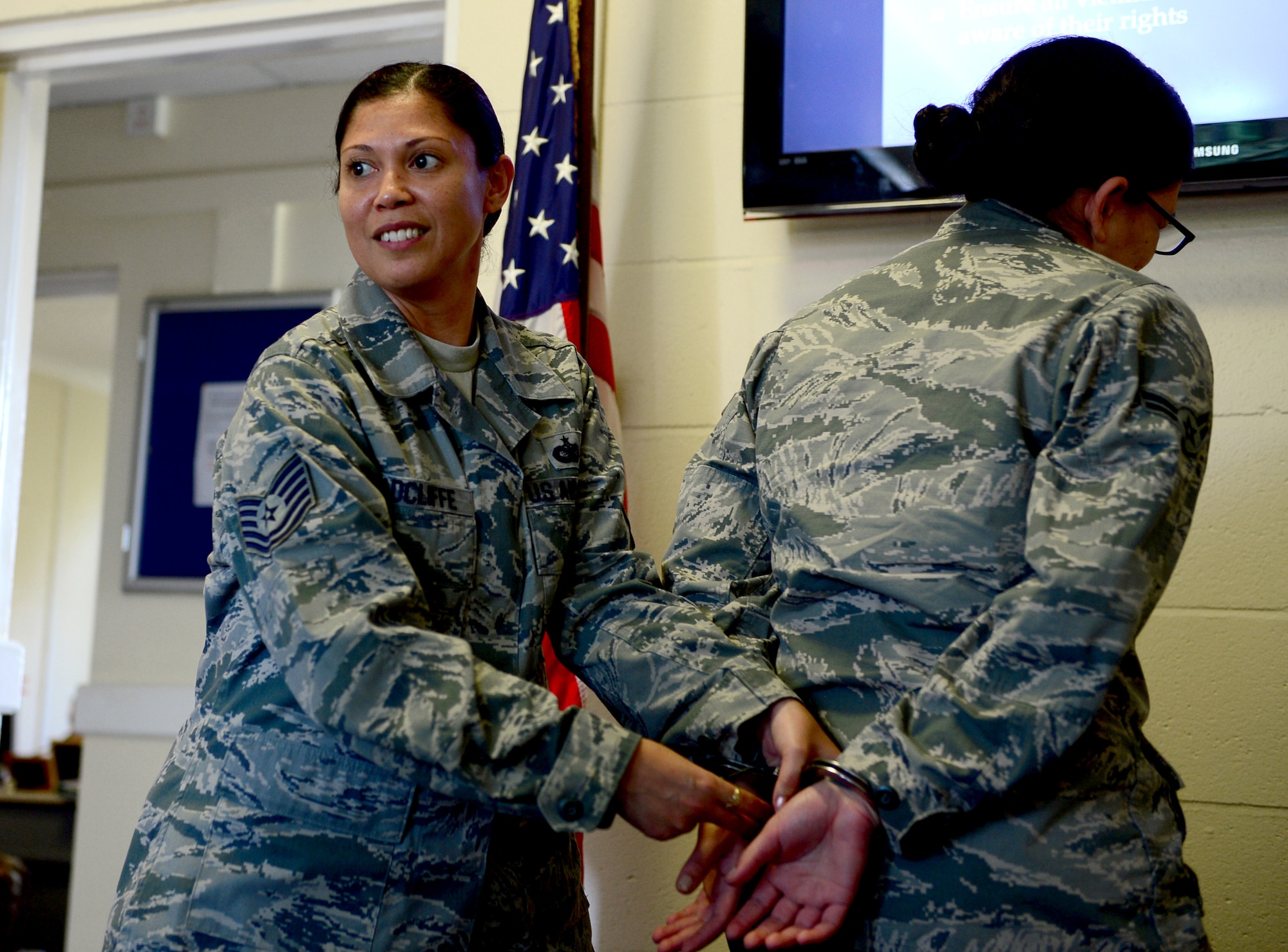 Tech. Sgt. Melissa Radcliffe, 48th Security Forces Squadron unit education and training manager, demonstrates handcuffing procedures to incoming security forces Airmen, at Royal Air Force Lakenheath, England, April 9, 2014. Radcliffe was nominated for a Liberty Spotlight because she displays the core value of ‘Service Before Self.’ (U.S. Air Force photo by Airman 1st Class Dawn M. Weber/Released)  