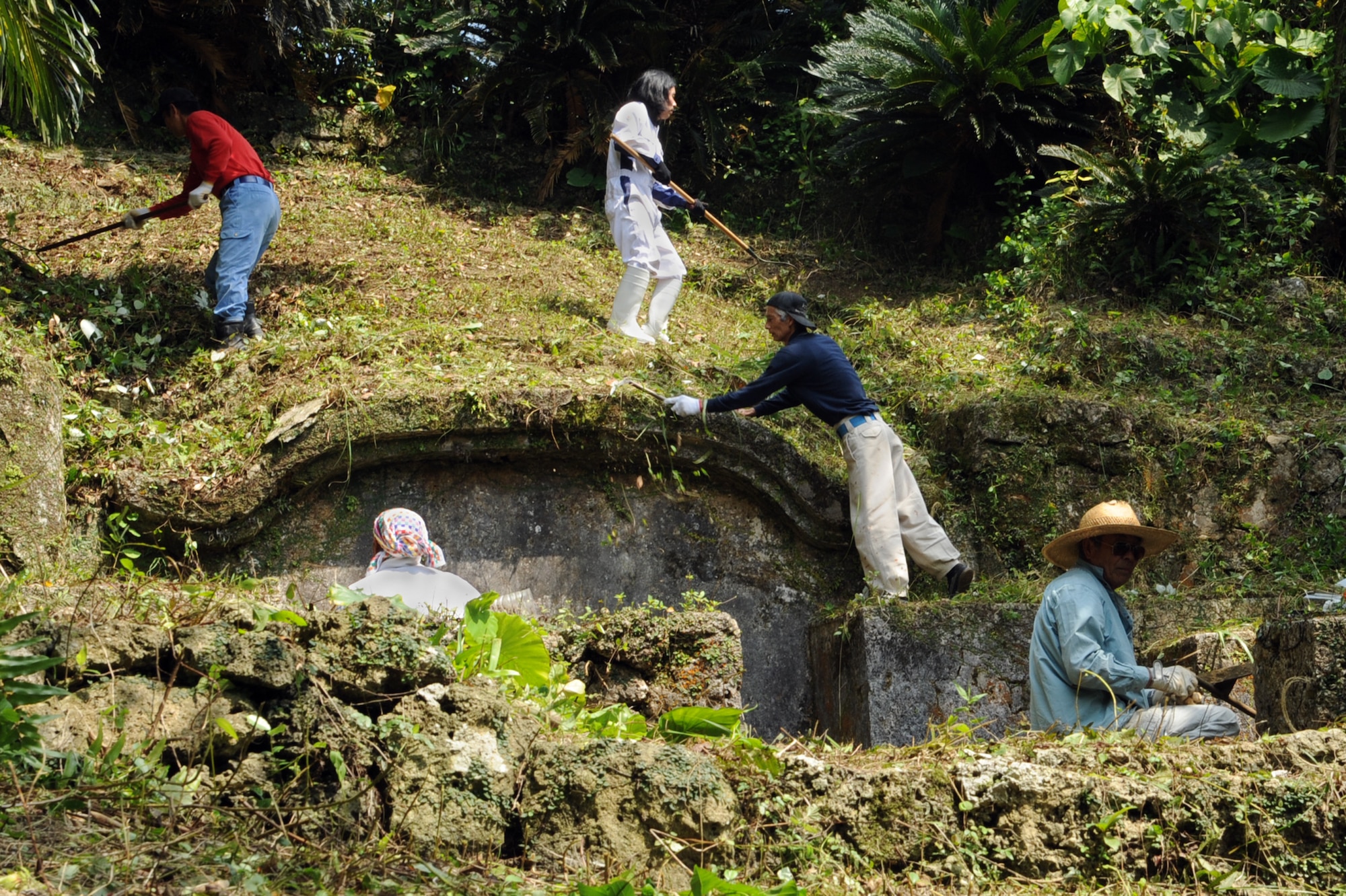Okinawans work to clean the exterior of their family tomb in preparation for Shimi on Kadena Air Base, Japan, April 6, 2014.  Shimi is an annual celebration on Okinawa, during which family tombs and the surrounding areas are cleaned before extended family members gather to pray and offer food to their deceased loved ones.  More than 400 locals visited the base this year to pray, eat and enjoy each other’s company.  (U.S. Air Force photo by Airman 1st Class Zade C. Vadnais) 
