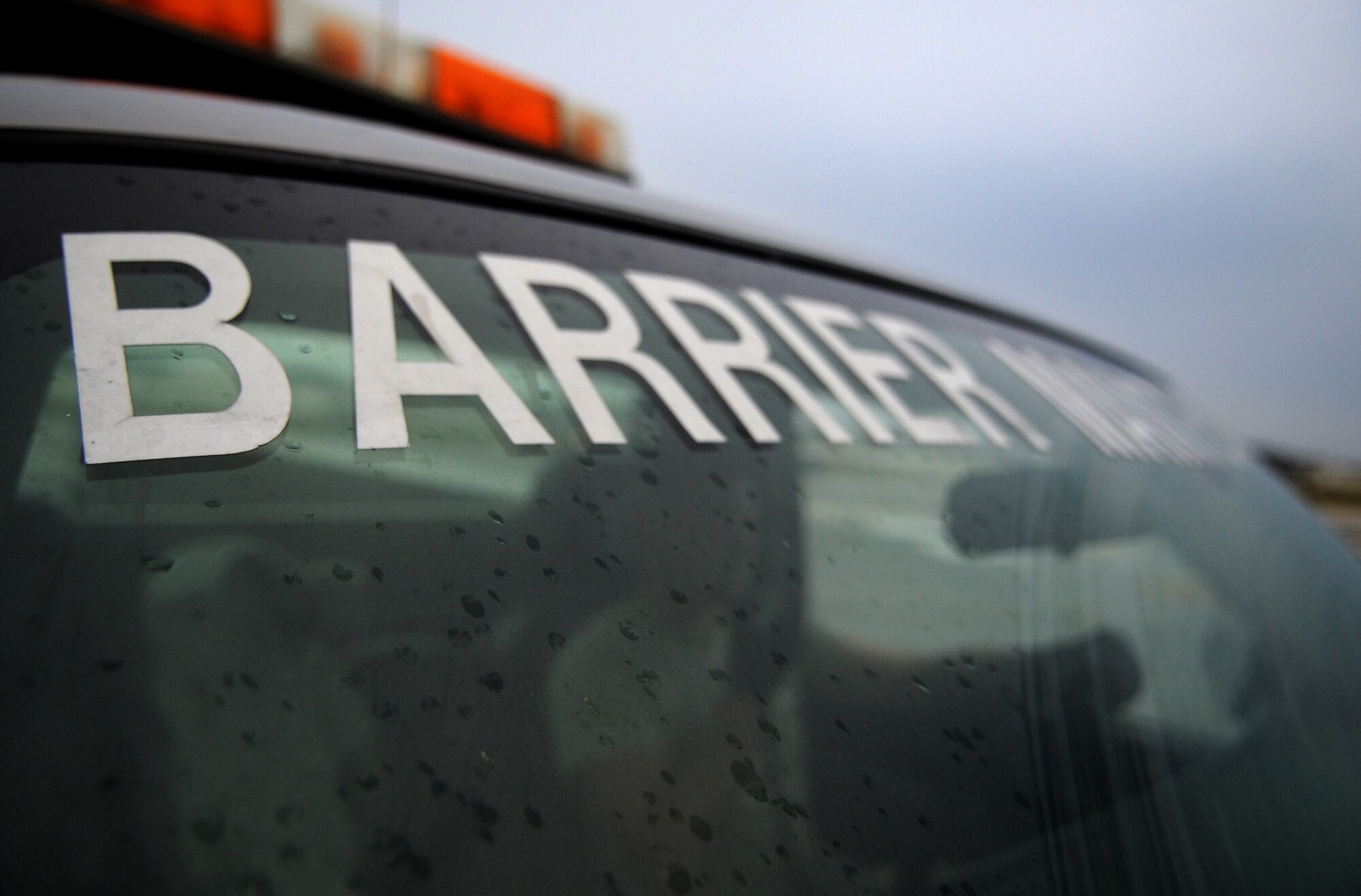U.S. Air Force Airman 1st Class Zachary Kennedy, 18th Civil Engineer Squadron power production apprentice calls in over the radio to the aircraft control tower on the flightline of Kadena Air Base, Japan, April 7, 2014. The barrier maintenance members work to ensure the BAK-12 Aircraft Arresting System is functioning properly by repairing the arresting tape, performing annual maintenance on the system and ensuring the system functions properly. (U.S. Air Force photo by Airman 1st Class Keith James)