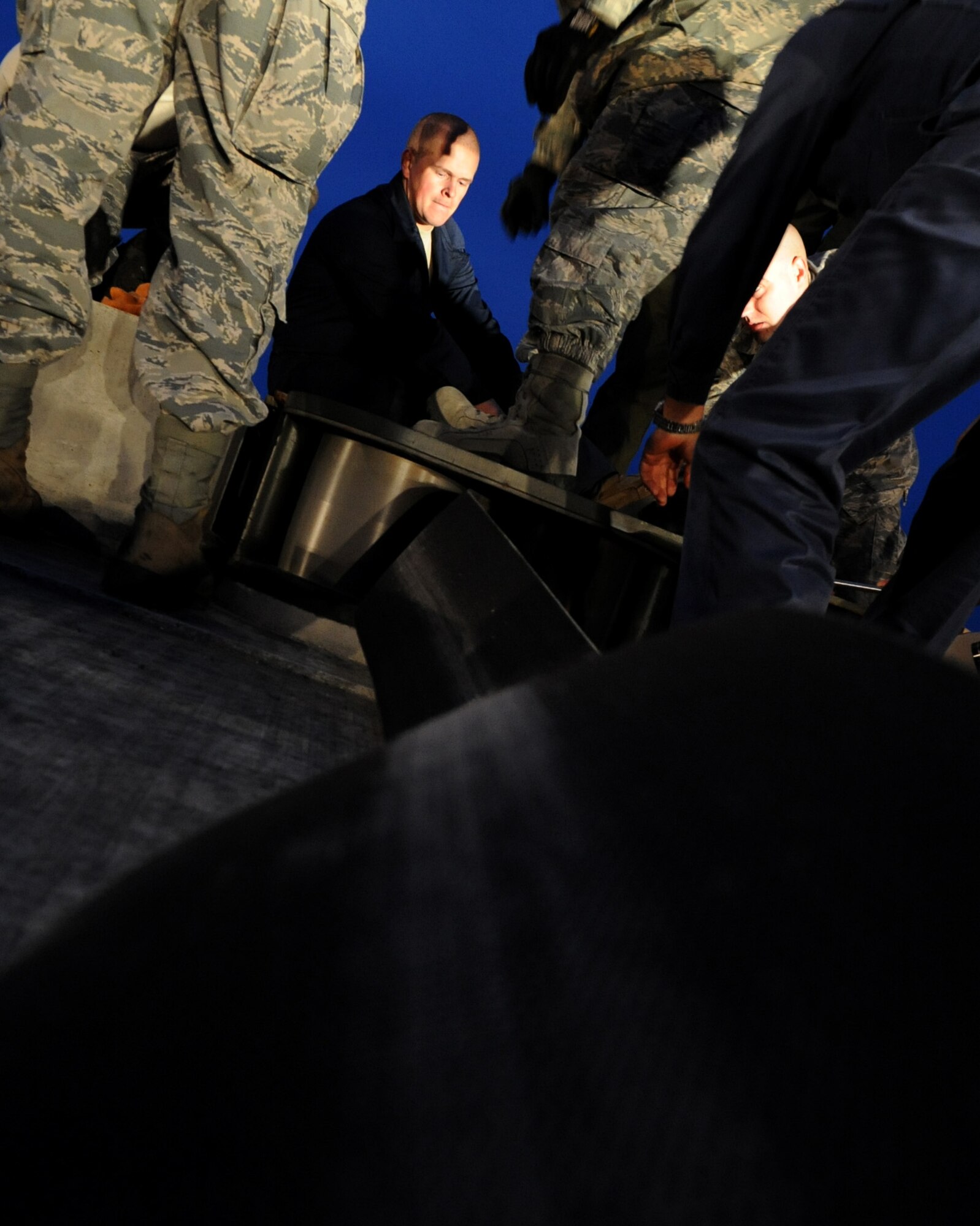 U.S. Air Force Airman 1st Class Isaac Vandeweert, 18th Civil Engineer Squadron power production apprentice, uses a breaker bar and Allen wrench to remove rusted bolts from a sheave cover on a BAK-12 Aircraft Arresting System on the flightline of Kadena Air Base, Japan, April 7, 2014. The BAK-12 Aircraft Arresting System uses nylon tape that absorbs the energy when the tail hook of an aircraft engages the barrier safely helping to stop the aircraft during its landing. (U.S. Air Force photo by Airman 1st Class Keith James)