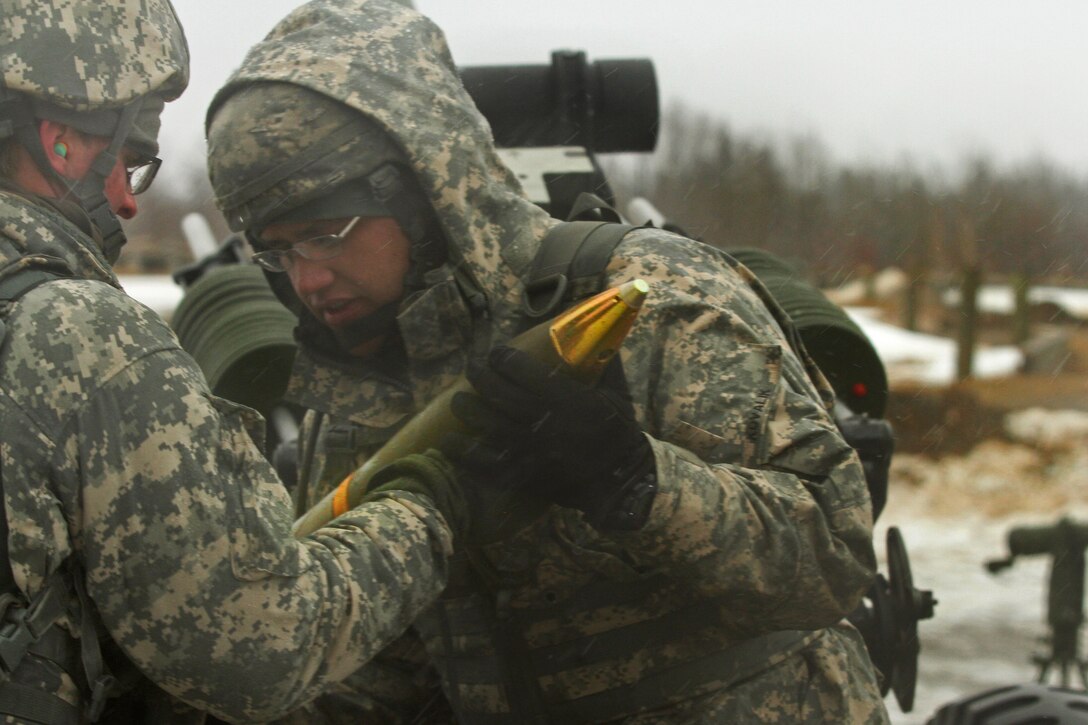 Army Sgt. Michael Kovalik prepares to load a round in his M105 Howitzer during a live-fire exercise on Fort Drum, N.Y., April 3, 2014. Kovalik, an ammo loader, is assigned to New York National Guard's Battery A, 1st Battalion, 258th Field Artillery.  