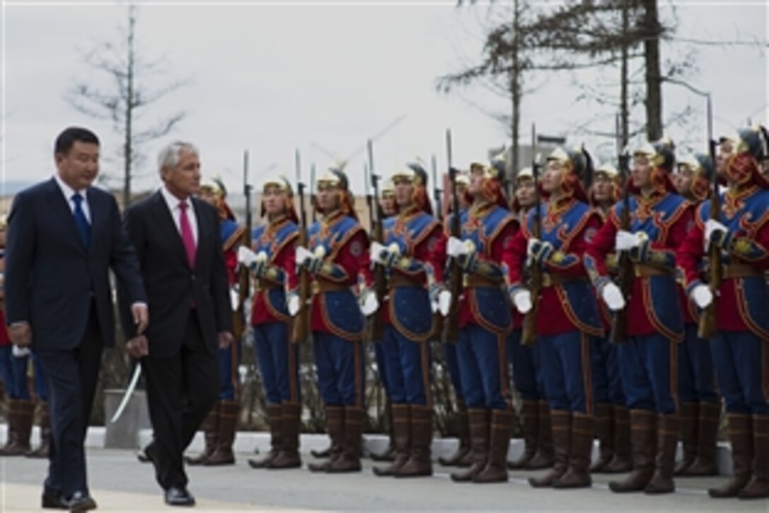 U.S. Defense Secretary Chuck Hagel, right, walks in a pass-and-review ceremony with Mongolian Defense Minister Dashdemberal Bat-Erdene during an honor cordon at the Mongolian Ministry of Defense in Ulaanbaatar, Mongolia, April 10, 2014. Hagel met with his counterparts to discuss issues of mutual importance. 