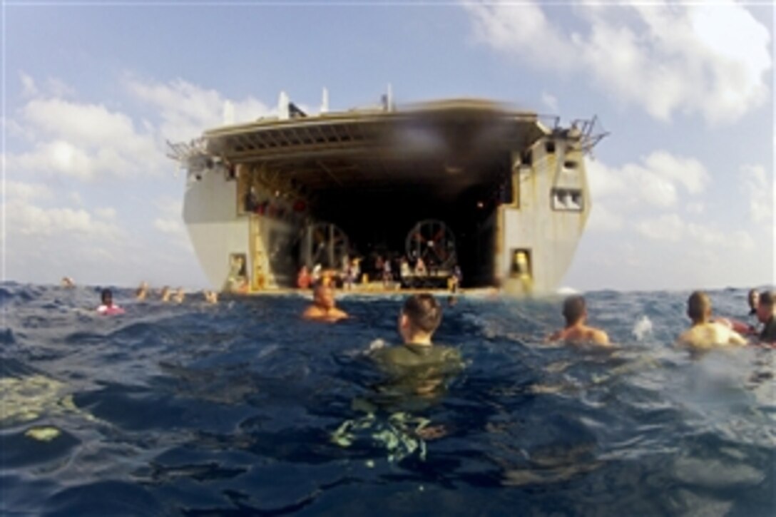 U.S. Navy sailors and Marines participate in a swim call off the stern gate of the amphibious transport dock ship USS Mesa Verde to celebrate the 121st birthday of the chief petty officer rank in the Arabian Sea, April 1, 2014. The Mesa Verde, with the embarked 22nd Marine Expeditionary Unit, is deployed to support maritime security operations and theater security cooperation efforts in the U.S. 5th Fleet area of responsibility. 