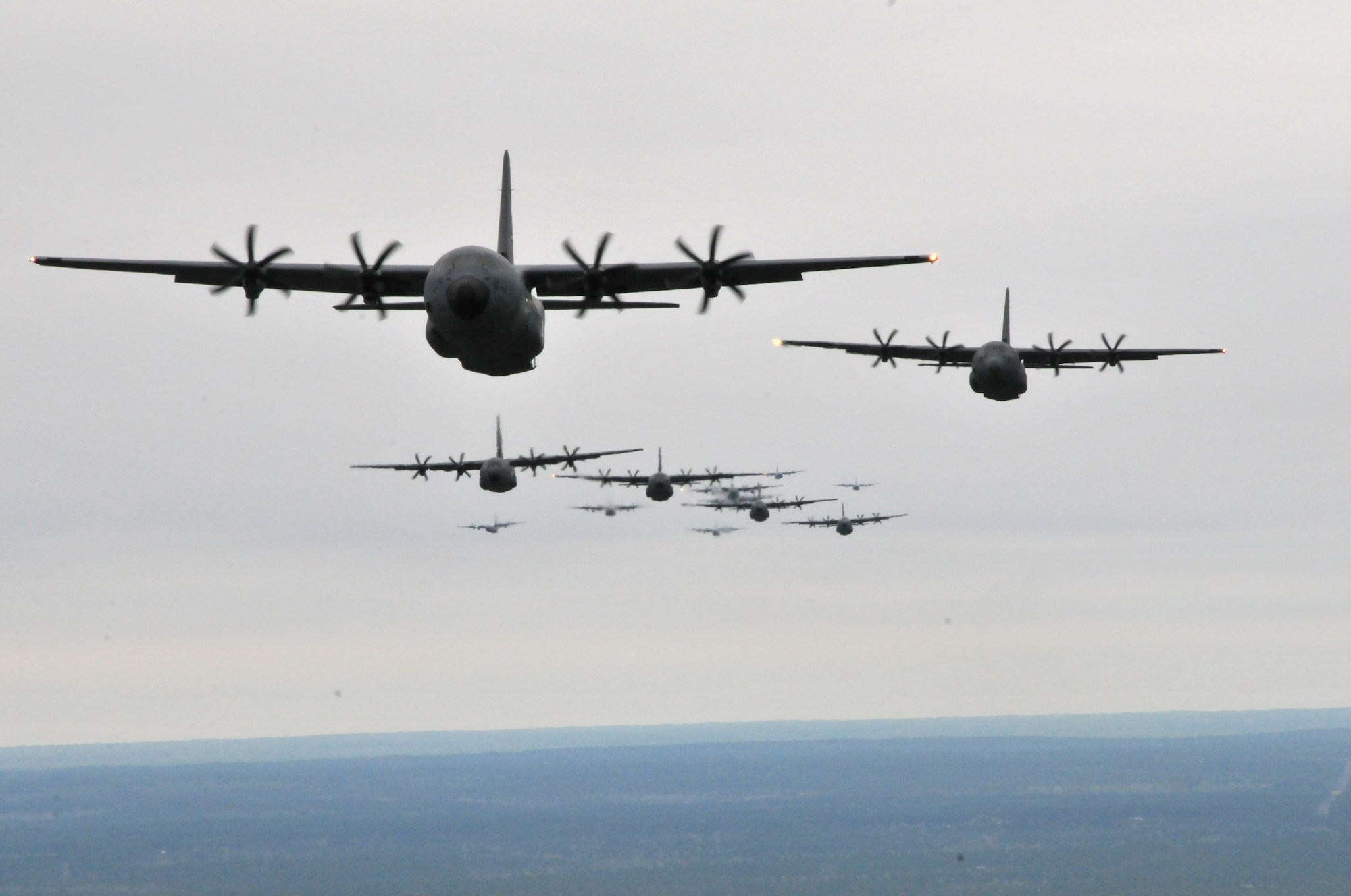 C-130J Hercules and WC-130J Hercules fly in formation during an Operation Surge Capacity exercise over the Mississippi Gulf Coast region April, 5, 2014. Aircraft from the 815th and 345th Airlift Squadrons and 53rd Weather Reconnaissance Squadron participated in the large-scale training exercise designed to test the 403rd Wing's ability to launch and recover a large formation of aircraft and to execute airdrops. The C-130s are assigned to the 403rd Wing at Keesler Air Force Base, Miss. (U.S. Air Force photo/Senior Airman Nicholas Monteleone)