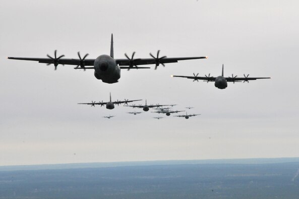 C-130J Hercules and WC-130J Hercules fly in formation during an Operation Surge Capacity exercise April, 5, 2014, over the Mississippi Gulf Coast region. Aircraft from the 815th and 345th Airlift Squadrons and 53rd Weather Reconnaissance Squadron participated in the large-scale training exercise designed to test the 403rd Wing's ability to launch and recover a large formation of aircraft and to execute airdrops. The C-130s are assigned to the 403rd Wing at Keesler Air Force Base, Miss. (U.S. Air Force photo/Senior Airman Nicholas Monteleone)