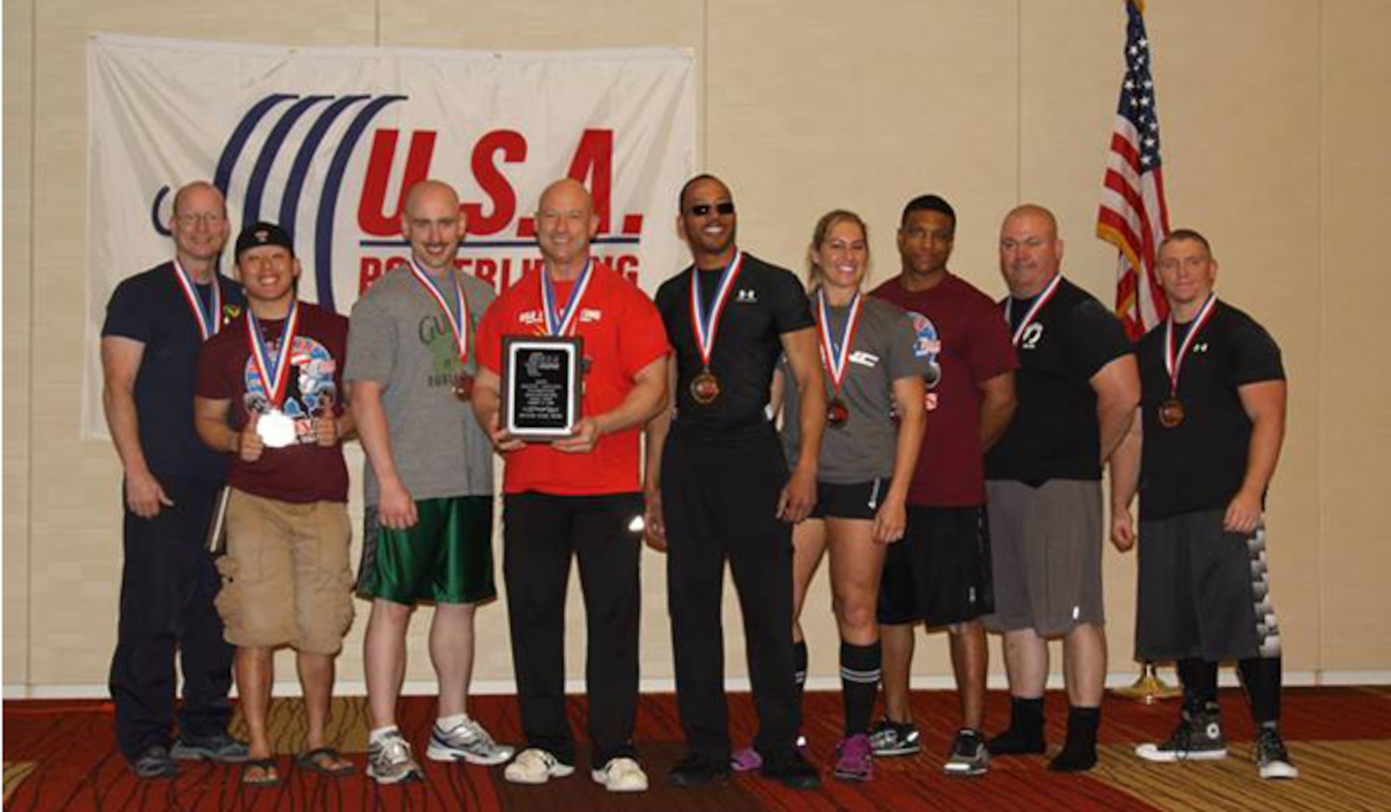 The Air Force team receives the second place award at the 2014 U.S. Military National Powerlifting Championships March 15, 2014, in Killeen, Texas. At the event, Chief Master Sgt. Troy Saunders, Pacific Air Forces vehicle management functional manager (fourth from left), earned 11 gold medals, five military national and four American records. (Courtesy photo)