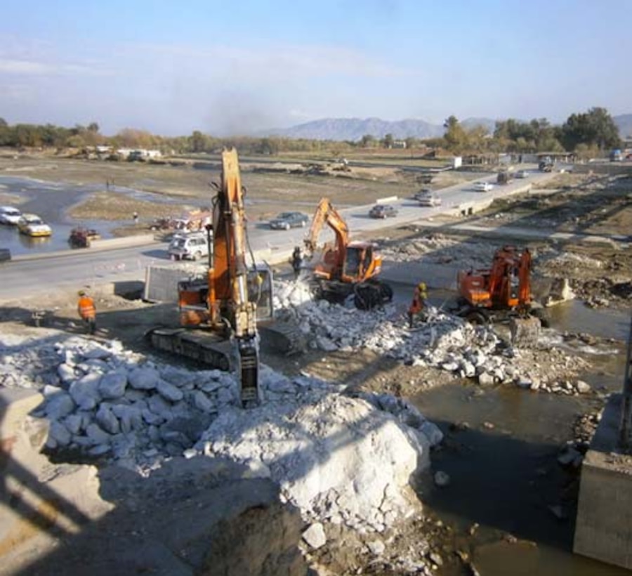 PMs Forward work very closely with customers to manage their planning, programming, and design requirements, helping to guide the customer and recommend solutions on program development. For Afghanistan’s AIF program, Pat Brierly is the PM Forward in Afghanistan for the AIF Program working this temporary high water bridge on the right and low water temporary crossing on left. The new bridge location is in the center.  