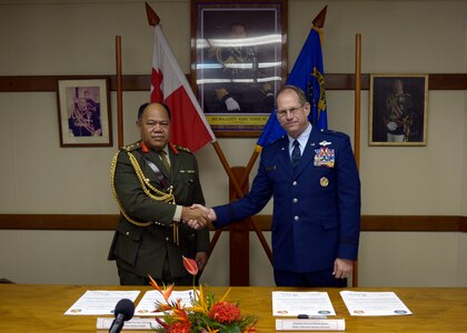 Brig. Gen. Tau'aika 'Uta'atu, Tonga chief of defense, and Brig. Gen. William Burks, Nevada adjutant general, shake hands after signing the National Guard State Partnership declaration. 
