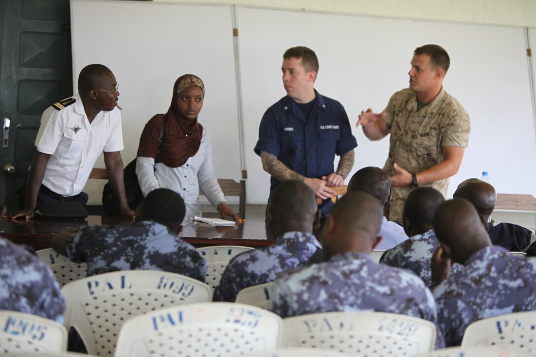 Lance Cpl. Tyler Jackson, a Marine with Special-Purpose Marine Air-Ground Task Force Africa 14.1, and Petty Officer 3rd Class Brian Spence, a Coastguardsman with U.S. Coast Guard Station Seattle, inspect a boat engine prior to starting a week-long training program designed to demonstrate proper small-boat engine mechanics to a group of sailors from the Togolese Navy in Lomé, Togo, March 24. Jackson and Spence put together a week-long training program of classroom instruction and practical application so the two groups of service members could partner together to fix engines. Established in 2011, Special-Purpose Marine Air-Ground Task Force Africa 14.1 is charged with supporting U.S. Africa Command and Marine Corps Forces Europe and Africa’s theater security cooperation requirements.