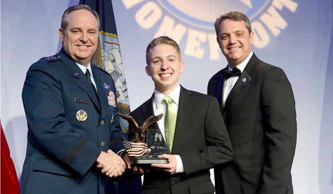 Air Force Chief of Staff Gen. Mark A. Welsh III (left) presents Gage Dabin the Air Force Military Child of the Year Award during the 6th annual gala hosted by Operation Homefront in Arlington, Va., April 10, 2014.  Gage, son of Senior Master Sgt. Tobias Adam and mother, Jennifer, were present and the family is stationed at Joint Base Elmendorf-Richardson, Alaska.  (U.S. Air Force photo/Scott M. Ash)