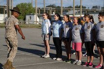 Spouses from Marine Aircraft Group 26 and Marine Tiltrotor Operational Test and Evaluation Squadron 22 learn how to march in the parking lot of AS-211 during an In Their Boots event aboard Marine Corps Air Station New River, N.C., April 5. Former drill instructors from the squadrons assisted in helping the spouses drill during In Their Boots. 

