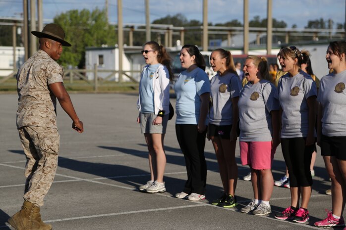 Spouses from Marine Aircraft Group 26 and Marine Tiltrotor Operational Test and Evaluation Squadron 22 learn how to march in the parking lot of AS-211 during an In Their Boots event aboard Marine Corps Air Station New River, N.C., April 5. Former drill instructors from the squadrons assisted in helping the spouses drill during In Their Boots. 

