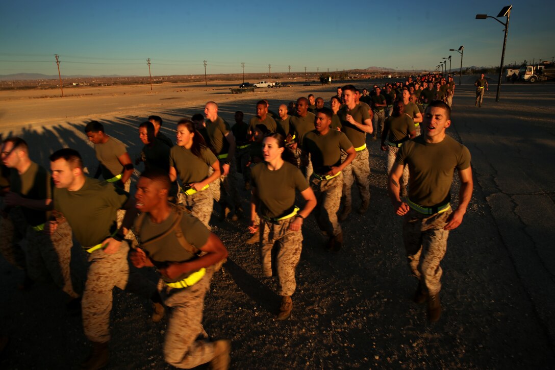 Marines sing cadence during a battalion three-mile motivation run along the Physical Fitness Test Track, April 4, 2014. “When you see the companies get together like this, it builds morale and brings the Marines together,” said Cpl. Paul Kelley, military working dog handler, Provost Marshal’s Office, Headquarters Battalion.
