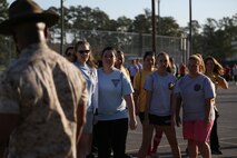 Spouses from Marine Aircraft Group 26 and Marine Tiltrotor Operational Test and Evaluation Squadron 22 learn how to march in the parking lot of AS-211 during an In Their Boots event aboard Marine Corps Air Station New River, N.C., April 5. Former drill instructors from the squadrons assisted in helping the spouses drill during In Their Boots. 

