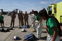 Headquarters and Headquarters Squadron spouses dress in Aircraft Rescue and Fire Fighting protective gear at the flight line aboard Marine Corps Air Station New River, April 5, during an In Their Boots Event. 


