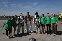 Headquarters and Headquarters Squadron spouses pose for a picture with Aircraft Rescue and Fire Fighting Marines on the flight line aboard Marine Corps Air Station New River, N.C., April 5, as apart of an In Their Boots event. During the event, spouses visited a static display of aircraft aboard the air station and viewed ARFF Marines give a demonstration of the speed they have to have during an emergency. 


