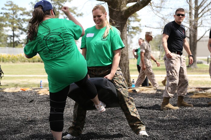 Carrie Colon, left, Marine spouse, trains in the Marine Corps Martial Arts Program aboard Marine Corps Air Station New River, April 5. Spouses were learning how to execute a groan kick during In Their Boots. 


