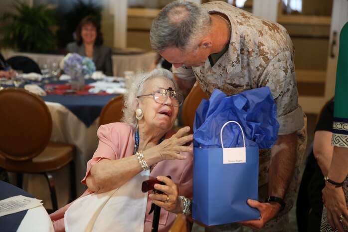 Col. Timothy M. Salmon, Marine Corps Air Station New River commanding officer, presents Bernice Rogers, Navy-Marine Corps Relief Society volunteer, with her award at the Officers Club aboard the air station, April 7. Rogers had approximately 300 hours of volunteer time. (U.S. Marine Corps photo by Lance Cpl. Andy J. Orozco/Released)


