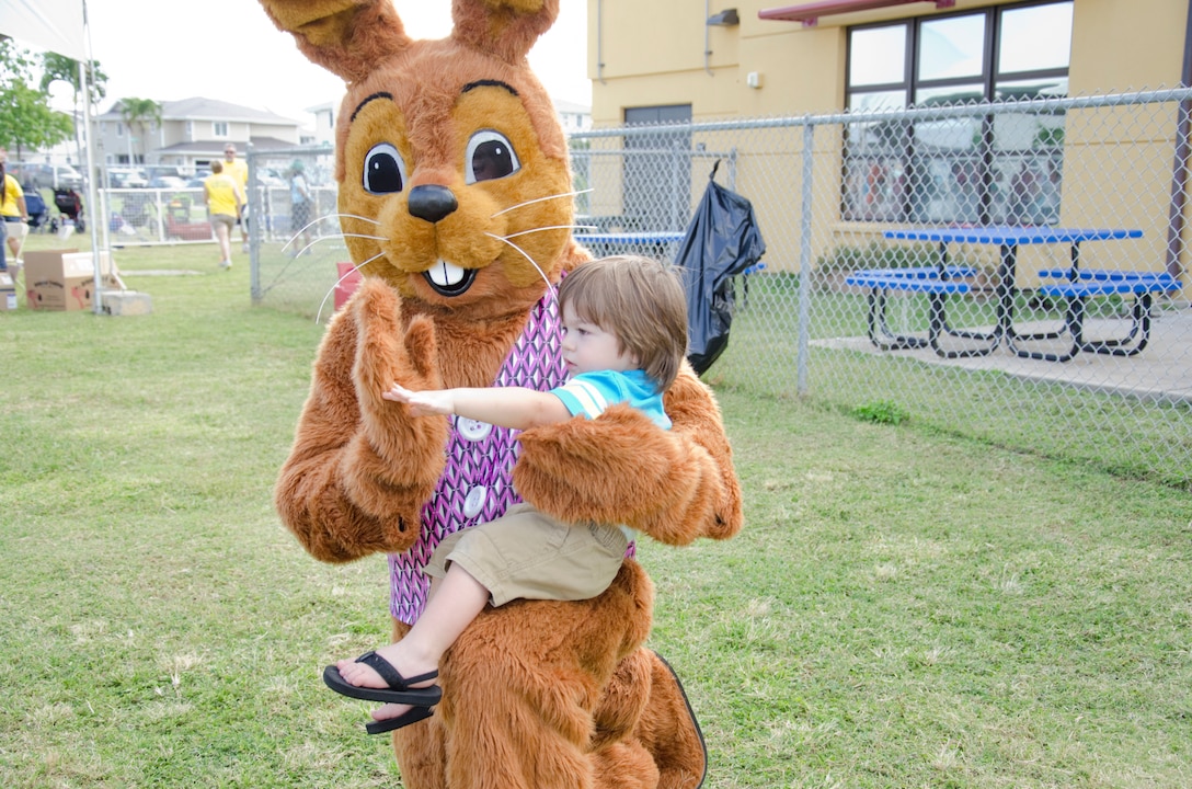 Daniel Croak Jr. gives the Easter Bunny a high five during the Spring Fair at the Kulia Youth Center, April 5, 2014. The Spring Fair featured various activities and rides for families. (U.S. Marine Corps photo by Kristen Wong)