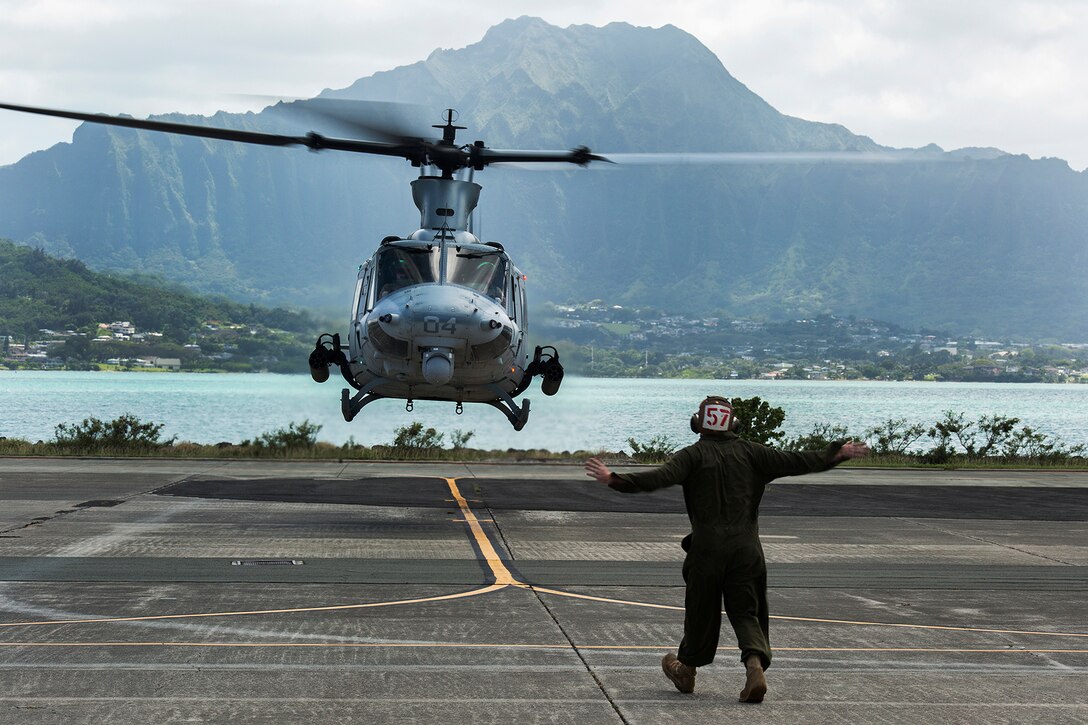 A maintenance Marine with Marine Light Attack Helicopter Squadron 367 signals the pilots of a UH-1Y Huey helicopter as it takes off from the flight line aboard Marine Corps Air Station Kaneohe Bay, Hawaii, April 9, 2014. HMLA-367 plays an important role in the everyday operations aboard Marine Corps Base Hawaii and has proven to be a vital asset in the Pacific as the Marine Corps begins to shift its focus back to the west. (U.S. Marine Corps photo by Lance Cpl. Matthew Bragg)