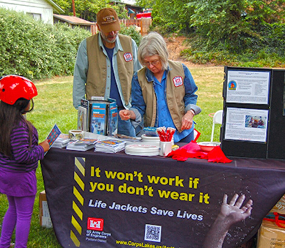 Tom and Velda Pierce have volunteered for events at The Dalles Lock and Dam for the past three and a half years, providing key support for popular events such as the Annual Eagle Watch, the Kids Fishing Day at Spearfish Park, and most recently helped during the Amazing Race Geocache event. In this photo, Tom and Velda are sharing information about the importance of water safety and wearing life jackets at the 2012 Childrens Safety Fair.