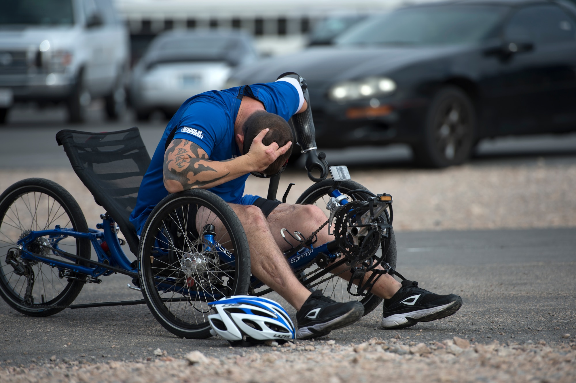 Leonard Anderson takes a moment to decompress after his race April 9, 2014, during the cycling portion of the Air Force Trials at Nellis Air Force Base, Nev.  Anderson, an Air Force wounded warrior, competed in the 12-mile men’s recumbent heat for an opportunity to make it on a team for the Warrior Games and Invictus Games.  (U.S. Air Force photo/Senior Airman Jette Carr)