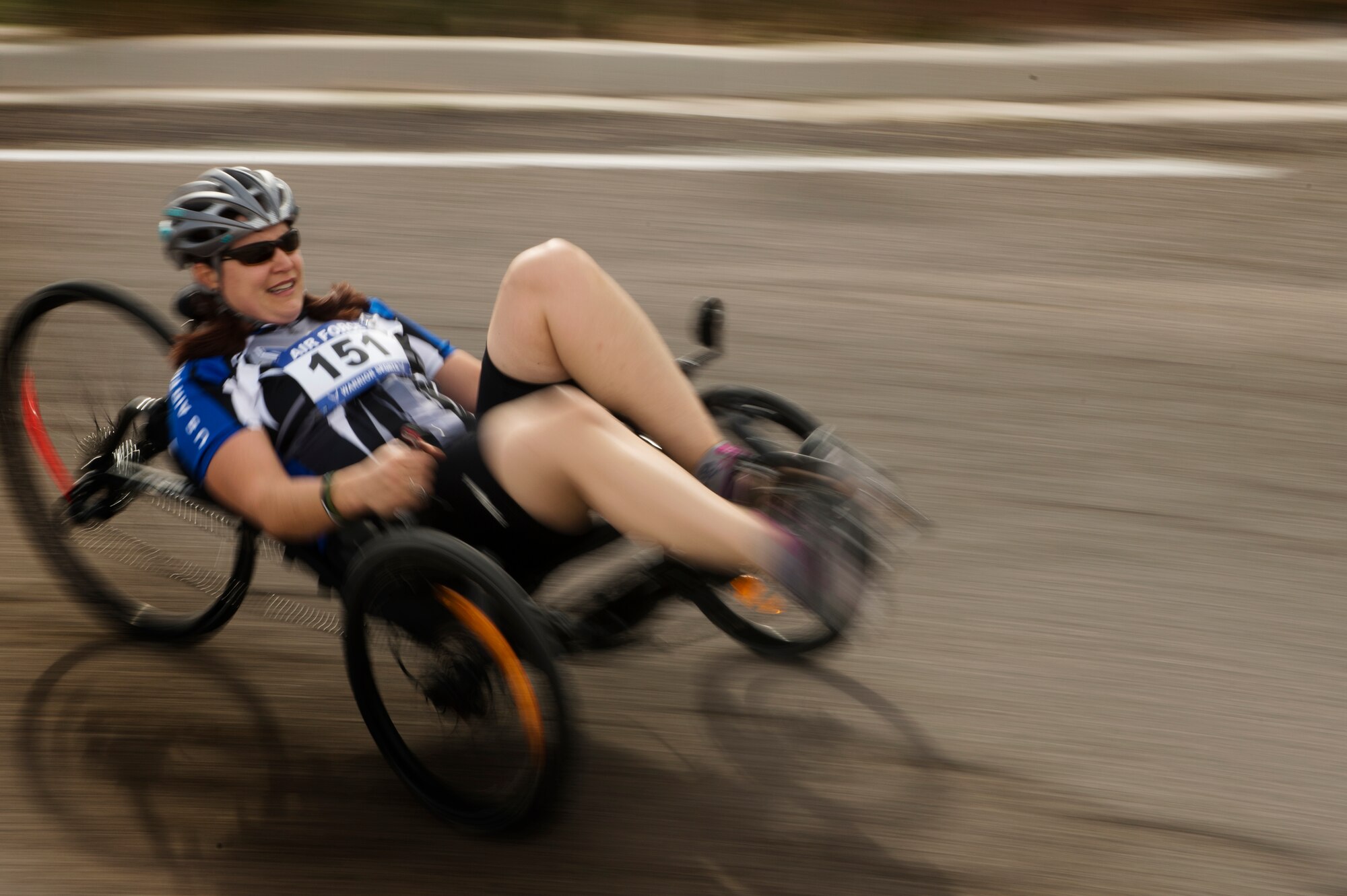 Jen Peters Kyseth sprints around a corner on a recumbent bike April 9, 2014, during the cycling portion of the Air Force Trials at Nellis Air Force Base, Nev.  Kyseth competed with other wounded warriors for a place on a team for the Warrior Games or Invictus Games.  (U.S. Air Force photo/Senior Airman Jette Carr)