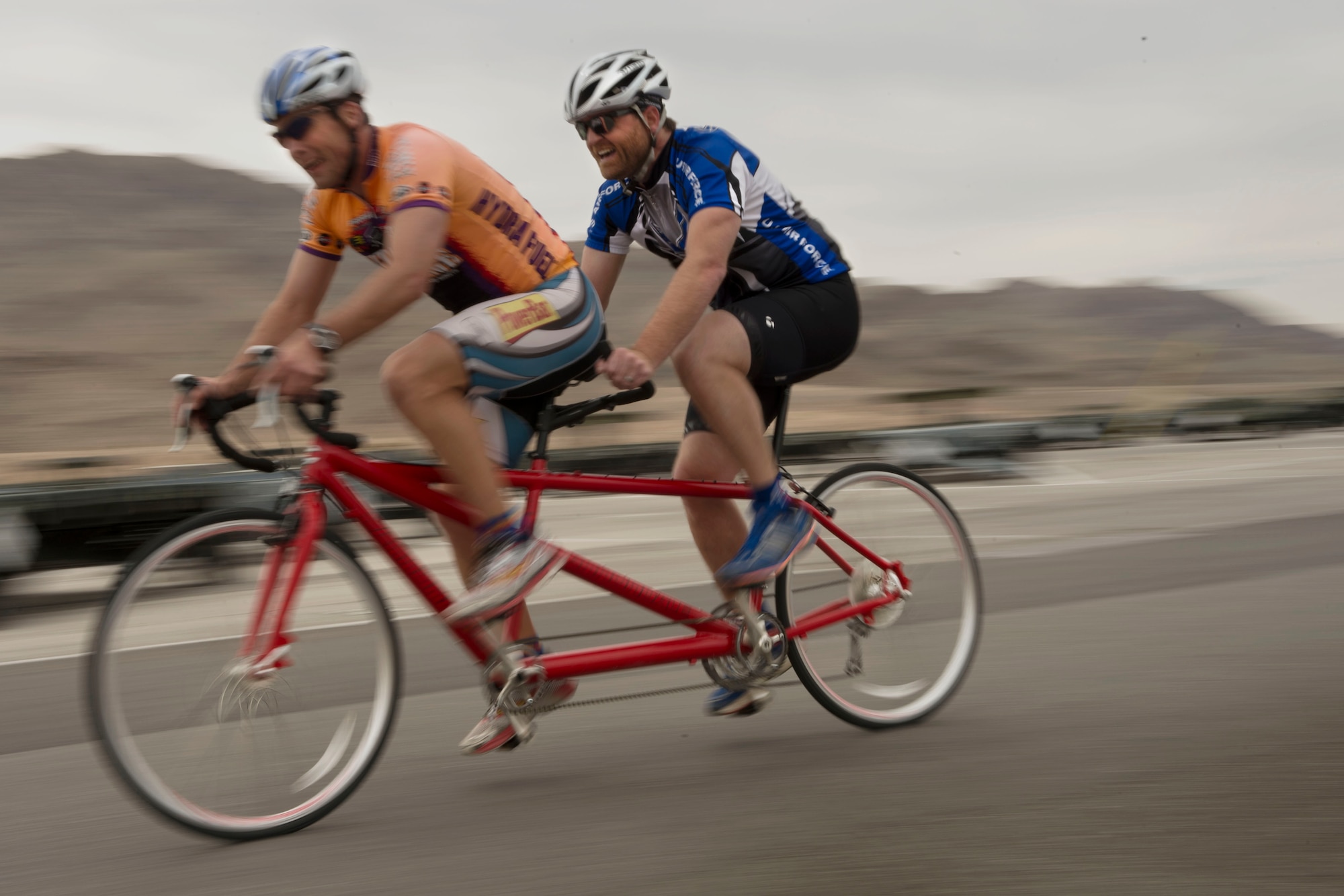 Maj. James Bales and Wes Glisson ride tandem April 9, 2014, during the cycling portion of the Air Force Trials at Nellis Air Force Base, Nev. Bales is the head coach for the Air Force team and works as a cycling pilot to help overcome Glisson’s visual impairment.  Both competed together in the tandem category during the 2013 Warrior Games and received the silver medal.  (U.S. Air Force photo/Senior Airman Jette Carr)