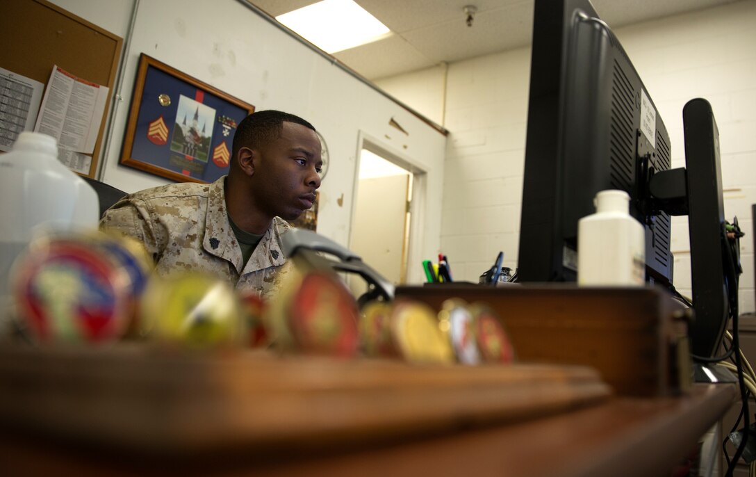 Sgt. Alan Hill, manpower and personnel chief with Marine Air Control Group 38, checks over his work aboard Marine Corps Air Station Miramar, Calif., April 9. Hill maintains constant technical efficiency and is relied upon by many Marines in his unit. 