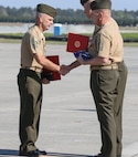 Sgt. Maj. Robert A. Allen Jr. receives awards and the national flag from Col. Timothy M. Salmon, Marine Corps Air Station New River commanding officer, during the retirement portion of the relief and appointment ceremony held aboard the air station, April 11. Allen relinquished his post as the air station sergeant major to Sgt. Maj. William H. Oldenburg. Allen retired after 30 years of faithful and honorable service. 