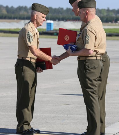 Sgt. Maj. Robert A. Allen Jr. receives awards and the national flag from Col. Timothy M. Salmon, Marine Corps Air Station New River commanding officer, during the retirement portion of the relief and appointment ceremony held aboard the air station, April 11. Allen relinquished his post as the air station sergeant major to Sgt. Maj. William H. Oldenburg. Allen retired after 30 years of faithful and honorable service. 