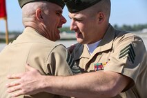 Sgt. Robert A. Allen III, Sgt. Maj. Robert Allen Jr.'s son, hug after the Marine Corps Air Station New River relief and appointment, and retirement ceremony held aboard the air station, April 11. Sgt. Allen served as the commander of troops during the ceremony, in which Sgt. Maj. Allen retired after 30 years of faithful and honorable service.