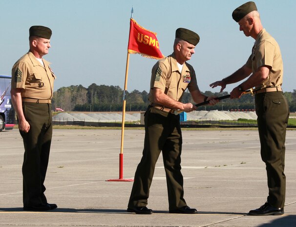 Sgt. Maj. Robert A. Allen Jr., center, outgoing sergeant major for Marine Corps Air Station New River, passes the noncommissioned officer sword to Col. Timothy M. Salmon, air station commanding officer, during the relief and appointment ceremony held at the air station, April 11. Allen relinquished his post as the air station sergeant major to Sgt, Maj. William H. Oldenburg. 