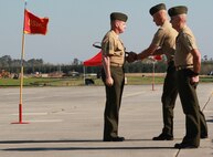 Col. Timothy M. Salmon passes the noncommissioned officer sword to Sgt. Maj. William H. Oldenburg during the Marine Corps Air Station New River relief and appointment ceremony held at the air station, April 11. Sgt. Maj. Robert A. Allen Jr. relinquished his post as the air station sergeant major to Oldenburg. 