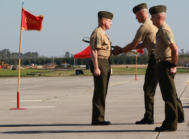 Col. Timothy M. Salmon passes the noncommissioned officer sword to Sgt. Maj. William H. Oldenburg during the Marine Corps Air Station New River relief and appointment ceremony held at the air station, April 11. Sgt. Maj. Robert A. Allen Jr. relinquished his post as the air station sergeant major to Oldenburg. 