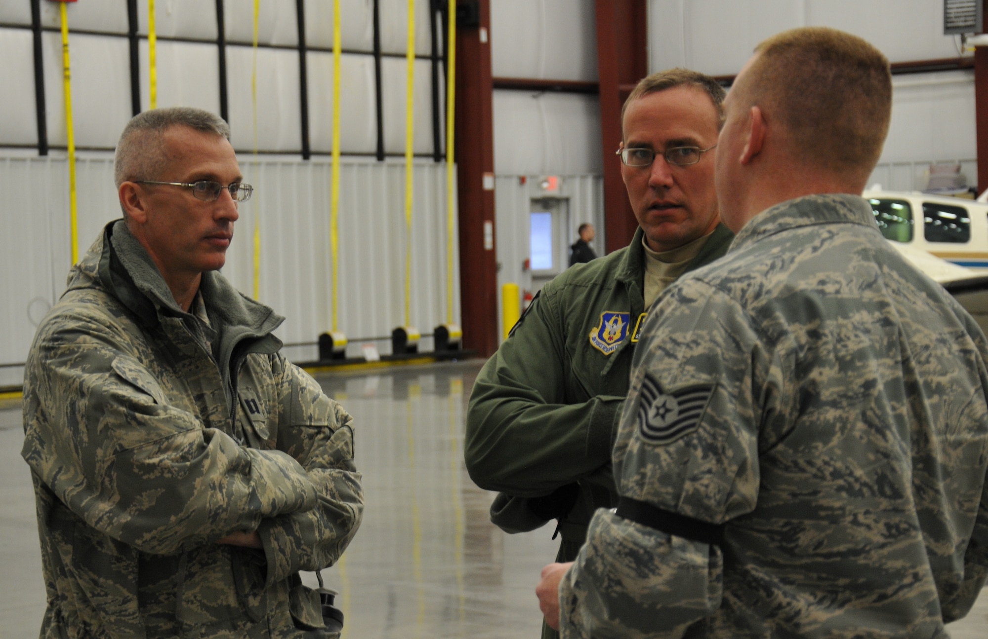 As part of a contingency response training event during the East Coast Combat Operations Exercise, Capt. John Glass (left), 512th Airlift Control Flight operations officer, consults with Staff Sgt. Darryl Santry (middle) and Tech. Sgt. Sean Ahearn, 512th ALCF loadmaster and radio frequency transmission specialist, about the next steps in setting up command and control operations April 7, 2014, at Griffiss International Airport, Rome, N.Y. En route to New York, the 512th ALCF team from Dover Air Force Base, Del., stoped in New Jersey to pick up communications equipment and more than 40 active-duty Airmen from the 621st Contingency Response Wing, Joint Base McGuire-Dix-Lakehurst, N.J. (U.S. Air Force photo/Senior Airman Joe Yanik)